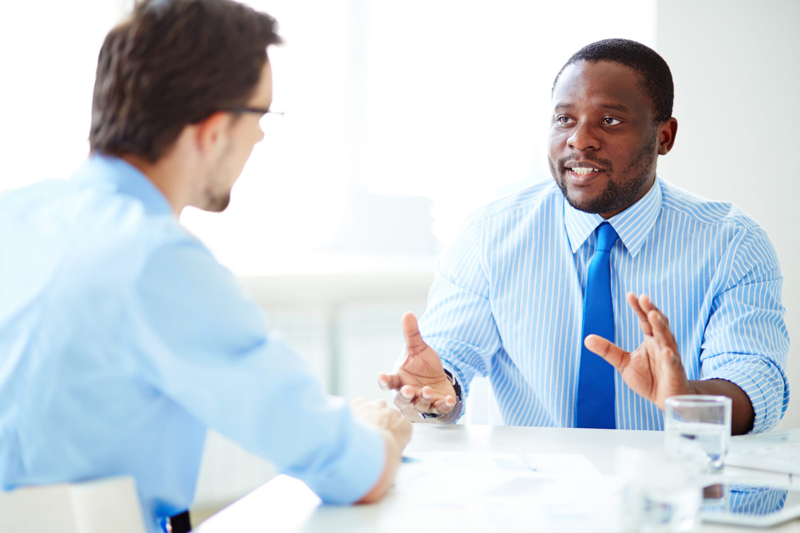 A confident professional negotiating a salary during a job interview, with a handshake symbolizing agreement on a successful offer